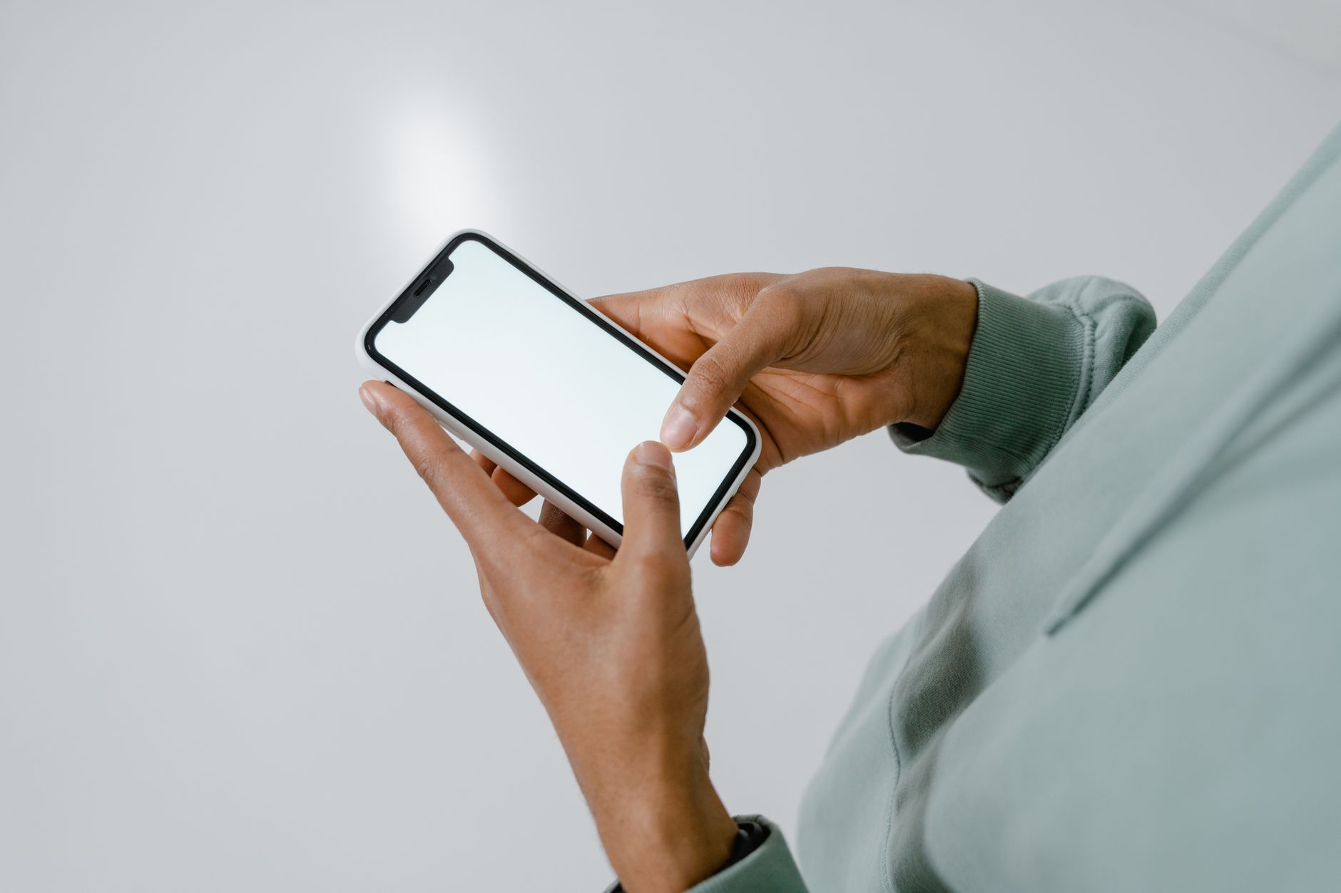 Person reading long article on iPhone with Claude AI app open