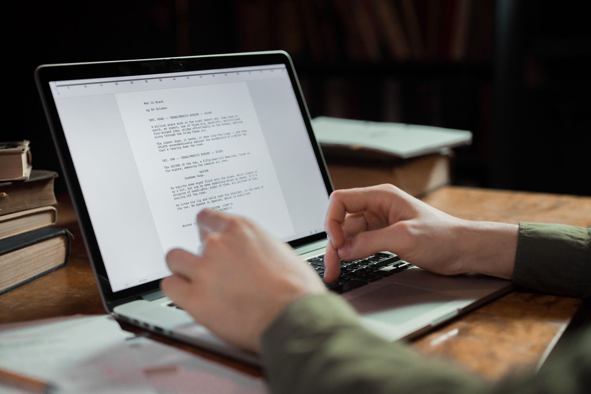 Person editing a written document on a laptop screen