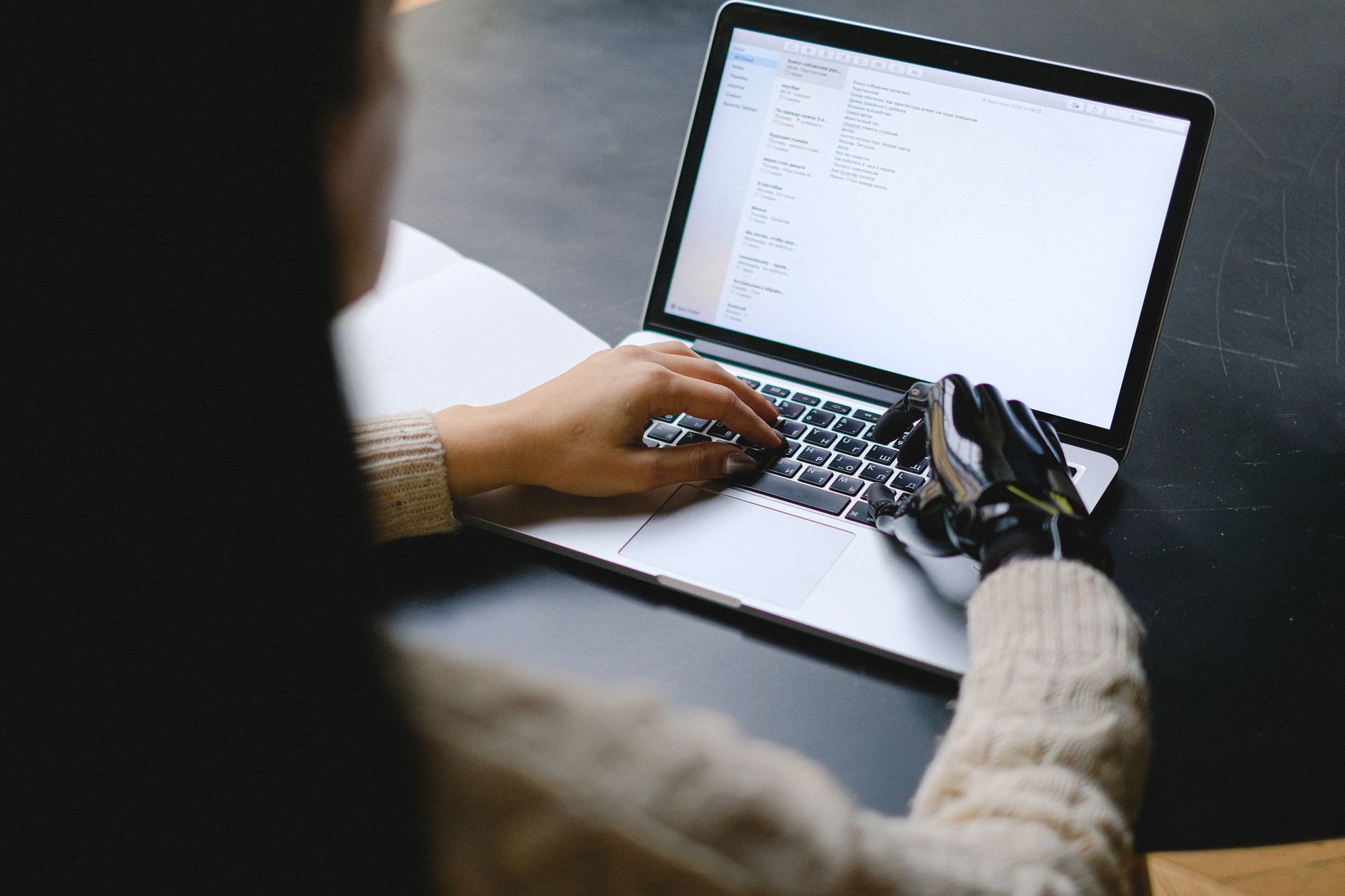 Person using Google Docs on laptop with AI side panel visible